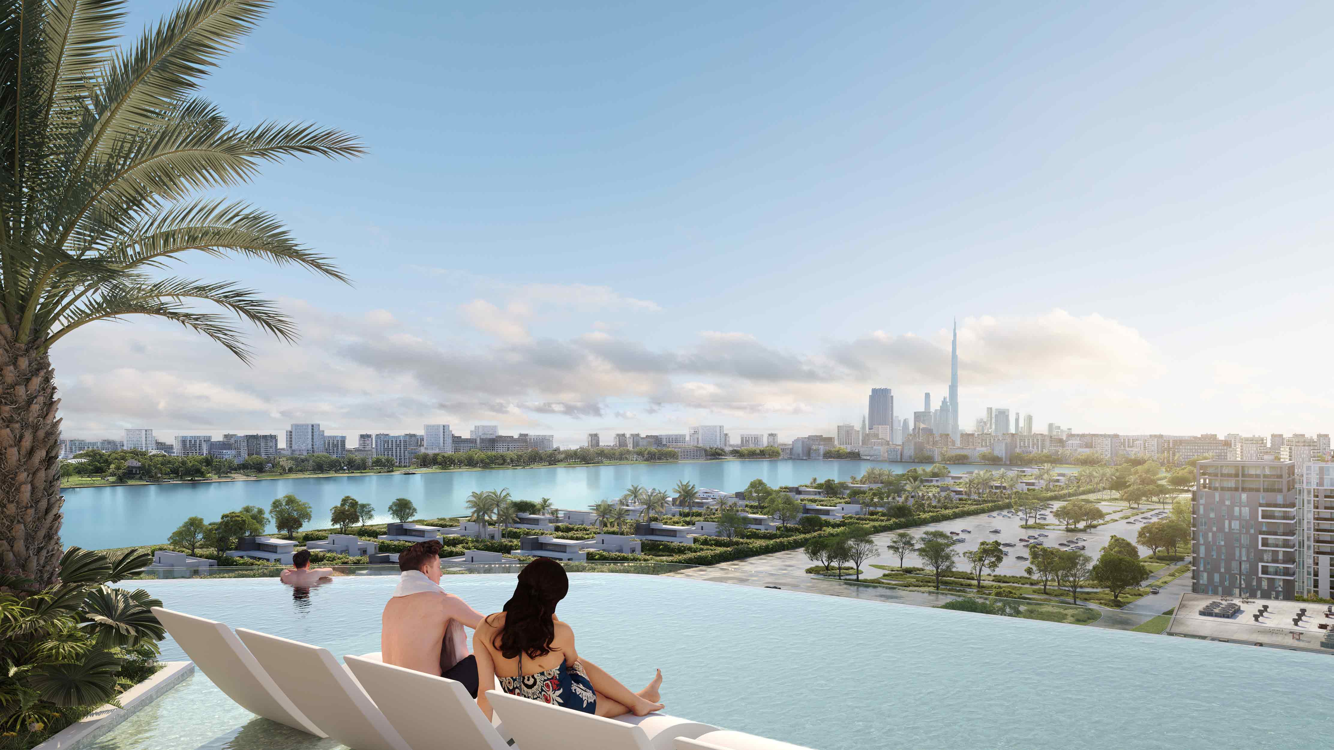 Sunset Bay Grand By Imtiaz A scenic view of a couple relaxing by an infinity pool, overlooking a city skyline and tranquil lake.